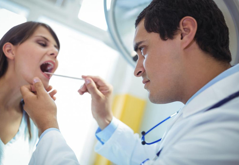 Doctor-checking-patient-for-tongue-cancer Doctor-checking-patient-for-tongue-cancer